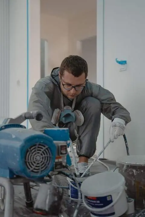 Setting up the sprayer for a basement job