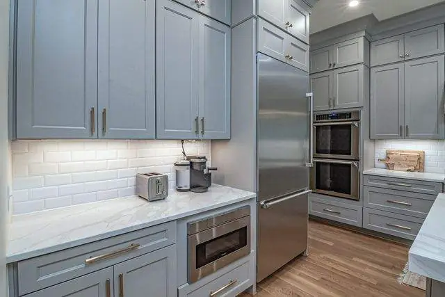 Blue-gray cabinets and built-in ovens