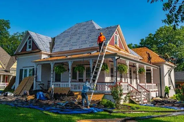 Tear-off and new underlayment, with the yard tarped below