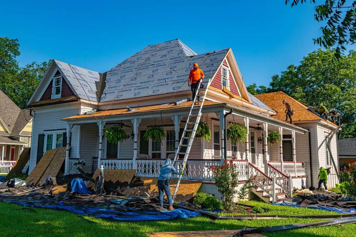 Tear-off and new underlayment, with the yard tarped below