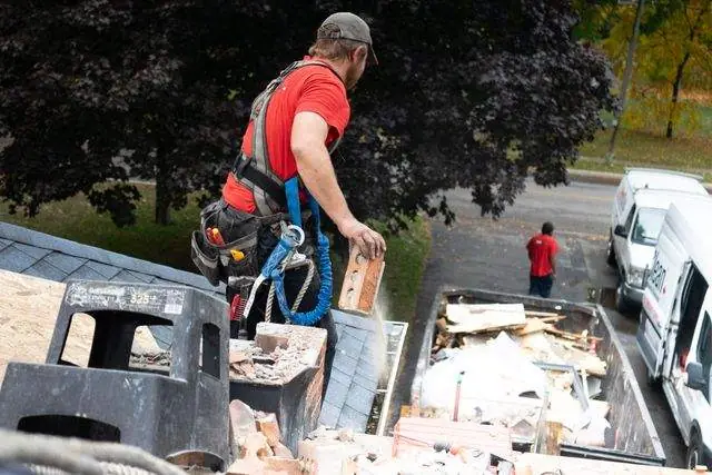 Old shingles going straight into the dumpster