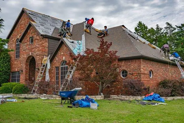 Crew working both sides of the main roof